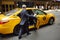 NEW YORK, USA - July 10, 2019: Street of Manhattan. Elegant man getting into yellow cab