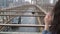 NEW YORK, USA - MAY 5, 2019: Brooklyn bridge at rain, girl looking at the road