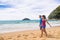 New Zealand beach couple hikers walking the coast track in Abel Tasman National Park. People tramping relaxing in nature outdoors