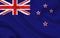 New Zealand country flag on wavy silk fabric background panorama