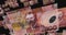New Zealand dollar 100 banknote â€“ flying between transparent money