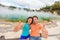 New Zealand happy tourist couple doing thumbs up at famous attraction travel destination. Champagne pool, Waiotapu. Active