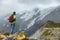 New Zealand hiker man hiking, enjoying view of snow capped mountain landscape in Hooker Valley track. Alps alpine