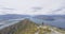 New Zealand hiker man on mountain top Roys Peak enjoying active lifestyle