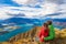 New Zealand hiking couple on mountain top Roys Peak enjoying active lifestyle