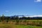New Zealand landscape - meadow bush trees mountain blue sky clouds -copyspace