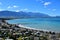 New Zealand landscape with the town Kaikoura, mountains and an ocean with turquoise water