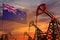 New Zealand oil industry concept. Industrial illustration - New Zealand flag and oil wells with the red and blue sunset or sunrise