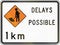 New Zealand road sign - Road workers ahead in 1 kilometre, delays possible