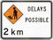 New Zealand road sign - Road workers ahead in 2 kilometres, delays possible