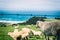 New Zealand sheep grazing on top of the hill with ocean view