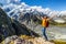 New Zealand success hiker man hiking at Mount Cook. Cheering adventure tourist reaching goal challenge on top of