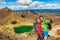 New Zealand Tongariro Alpine Crossing Hiking tourists couple selfie at Emerald Lakes. Happy backpackers tramping taking