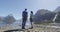 New Zealand - tourists hiking standing looking at Milford Sound