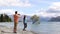 New Zealand tourists taking phone pictures of Wanaka Lone Tree at lake