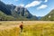 New Zealand tramping hiker man walking at Routeburn Track, Fiordland National Park at Te Anau. Travel destination for hiking