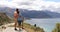 New Zealand travel adventure couple stopping at view point looking at mountains