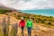 New Zealand travel - couple tourists hiking in nature with view of Lake Pukaki near Aoraki aka Mount Cook at Peter's