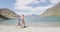 New Zealand travel happy tourist couple walking at beach of lake Hawea nature