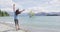 New Zealand travel happy tourist woman jumping of joy at Wanaka lake tree