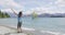 New Zealand travel happy tourist woman jumping of joy at Wanaka lake tree