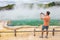 New Zealand travel tourist taking phone picture of famous attraction Champagne pool, Waiotapu. Active geothermal area, Okataina