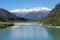 New Zealand views white mountains stand surrounded with green an