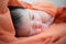 Newborn Asian baby girl on bed