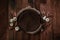 Newborn autumn background - wooden bowl with fall leaves and cream pumpkins on dark wooden planks backdrop