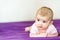 Newborn baby with adorable face, calm and relaxed lying on his bed