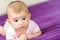 Newborn baby with adorable face, calm and relaxed lying on his bed