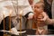 Newborn baby baptism in Holy water. baby holding mother`s hands. Infant bathe in water. Baptism in the font