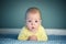 Newborn baby boy on blue carpet closeup