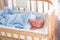 Newborn baby boy in hospital cot