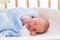 Newborn baby boy in hospital cot