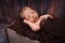 Newborn Baby Boy Sleeping in a Rustic Crate