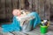 Newborn baby boy sleeping in a silver metal bucket