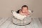 Newborn Baby Boy Sleeping in a Wire Basket