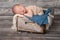 Newborn Baby Boy Sleeping in a Wooden Crate