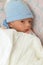 Newborn baby boy wearing a cap