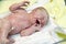 Newborn baby child seconds and minutes after birth lying on towel