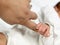 Newborn baby clasping the mothers finger