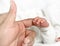 Newborn baby clasping the mothers finger