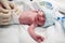 Newborn baby covered in vernix getting nappy