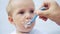 newborn baby eats from a spoon, close-up portrait grimy face. newborn baby at home kid dream concept. Newborn baby son