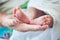 Newborn baby feet on grandmother hand