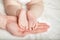 Newborn baby feets in parent hands at home