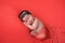 Newborn Baby Girl on a Coral Colored Background