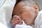 Newborn baby girl in hostpital bed sleeping