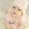 Newborn baby girl in pink knitted hat.